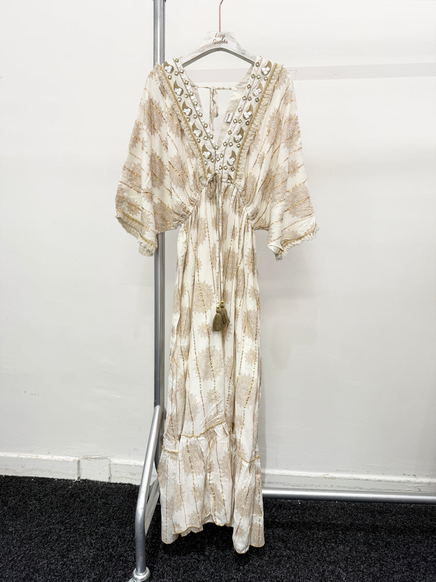 PRINTED MAXI DRESS WITH FLARED SKIRT AND LOOSE FIT TOP. DEEP V NECK FRONT AND BACK AND EMBELLISHED NECKLINE