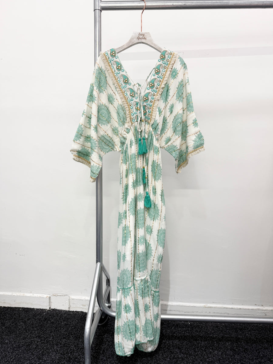 PRINTED MAXI DRESS WITH FLARED SKIRT AND LOOSE FIT TOP. DEEP V NECK FRONT AND BACK AND EMBELLISHED NECKLINE