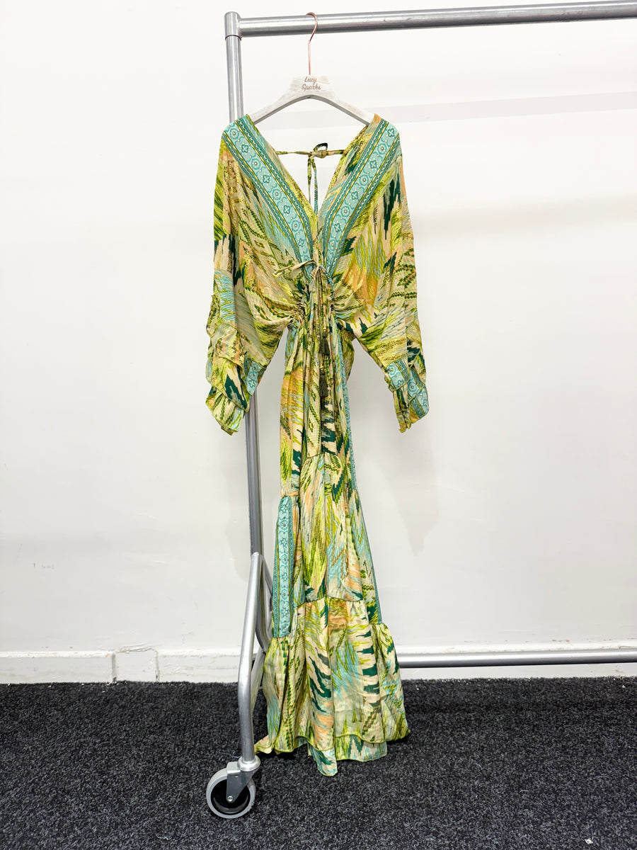 CHEVRON AND ANIMAL PRINTS DEEP V NECK FRONT AND BACK. FLARED MAXI DRESS WITH MULTI RUFFLE LAYERED SLEEVES AND HEM.