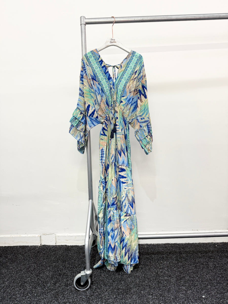 CHEVRON AND ANIMAL PRINTS DEEP V NECK FRONT AND BACK. FLARED MAXI DRESS WITH MULTI RUFFLE LAYERED SLEEVES AND HEM.