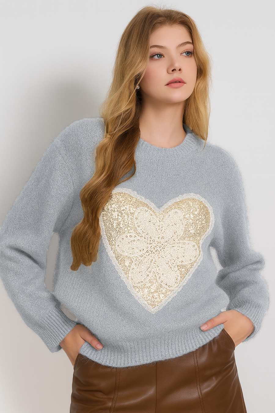 knitted jumper with heart shaped sequins encasing a laced flower design