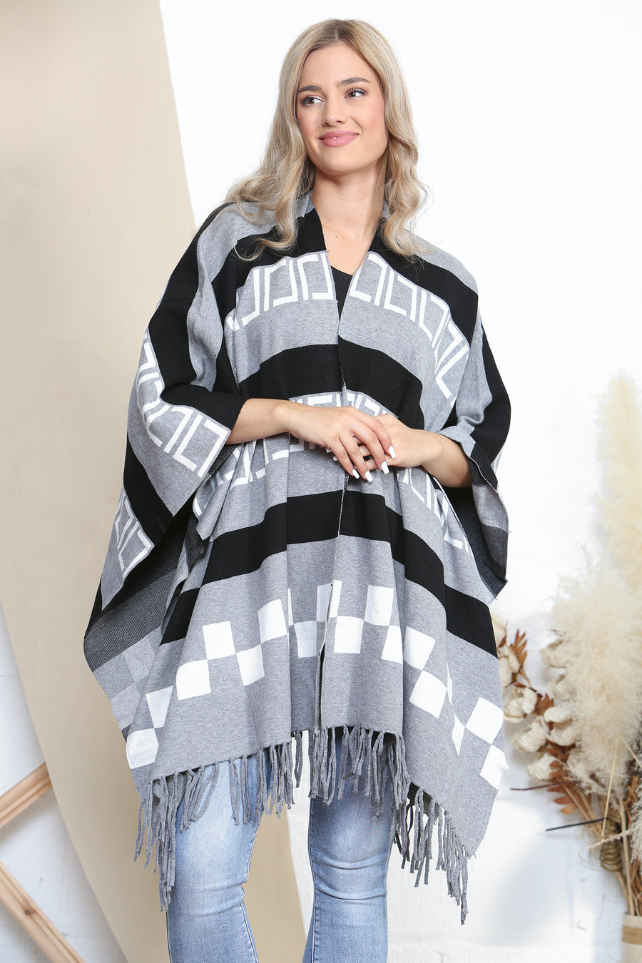 Pattered poncho with tassels