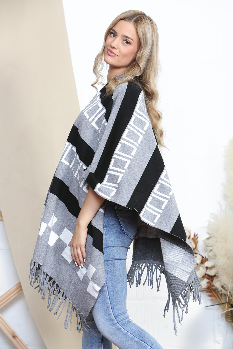 Pattered poncho with tassels