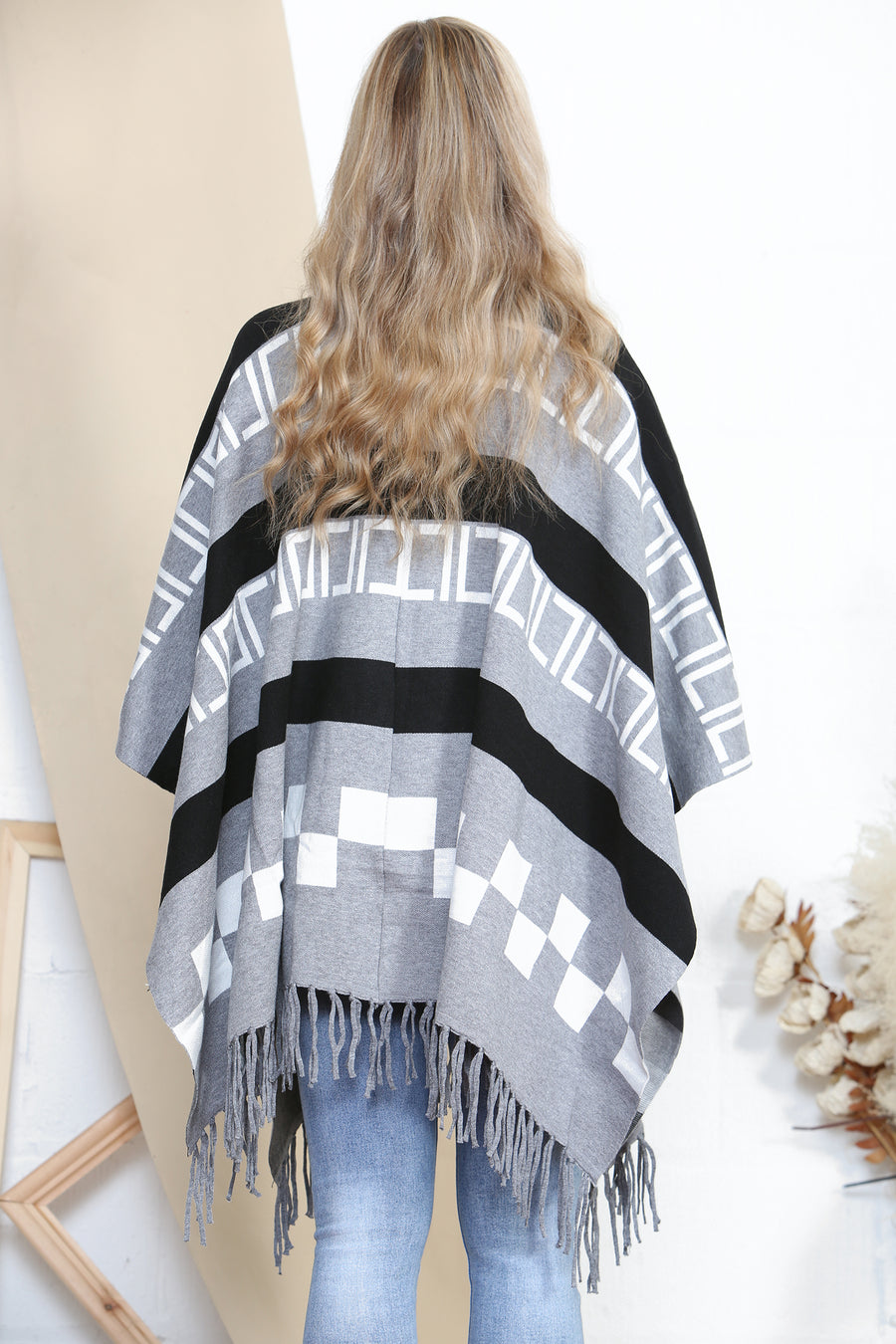 Pattered poncho with tassels