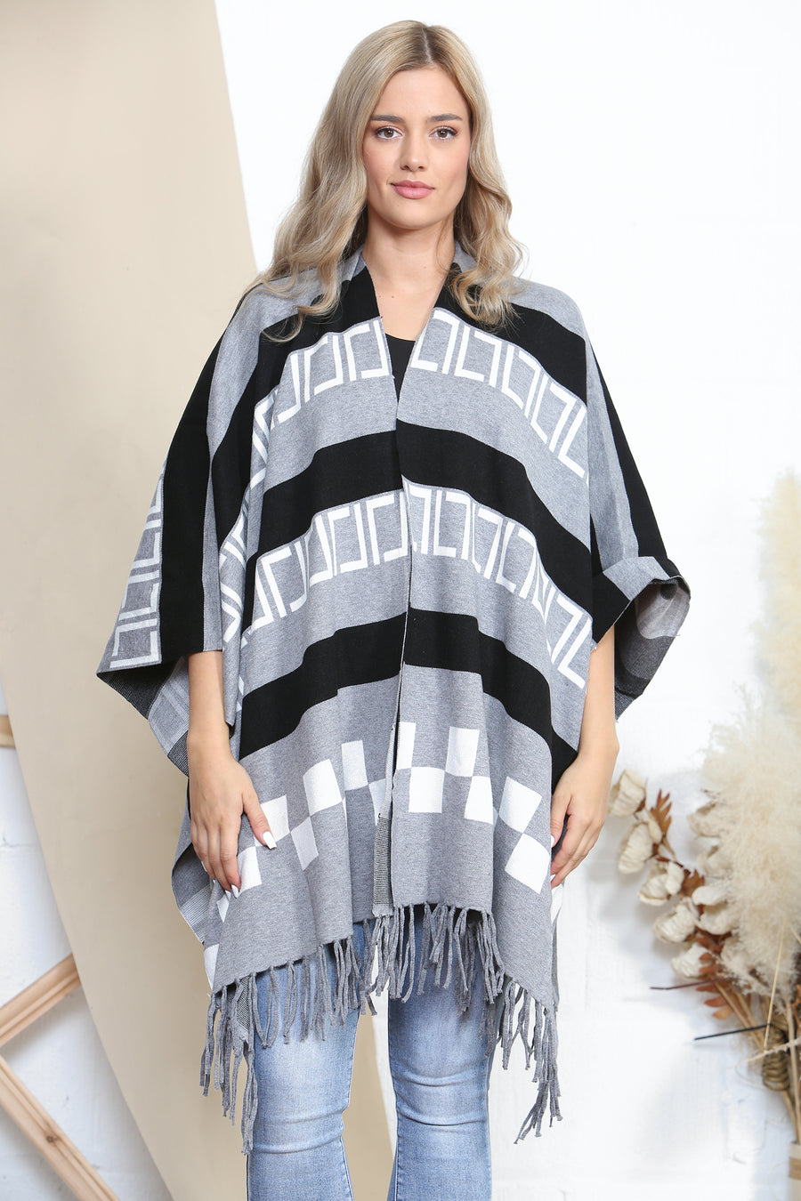 Pattered poncho with tassels