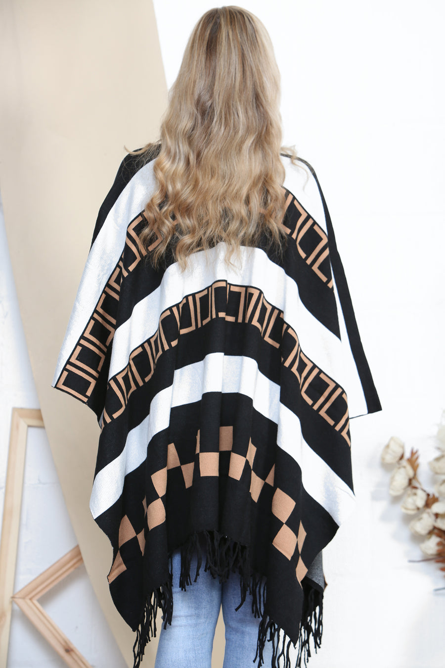 Pattered poncho with tassels