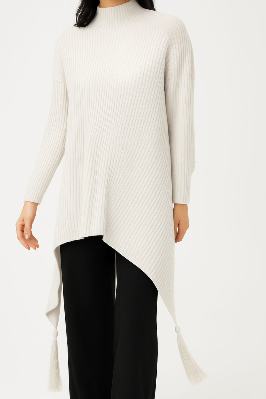 SOFT MULTI DIRECTIONAL KNIT JUMPER WITH ELONGATED SIDES AND TASSELS