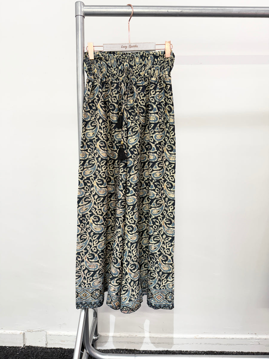 FLARED LEG SILKY TROUSERS WITH TASSEL WAIST TIE FULLY PRINTED
