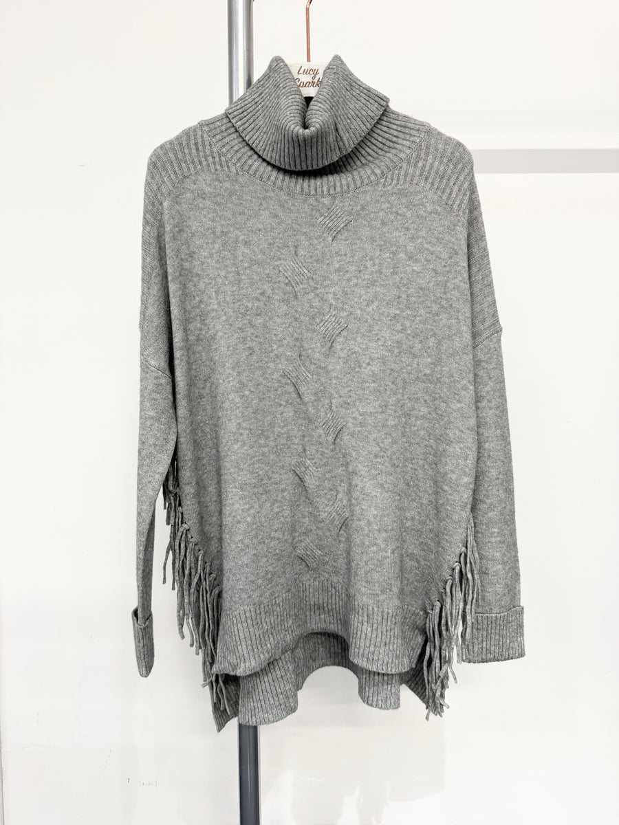 Soft Knit Jumper With Roll Neck,Rolled Sleeve Cuffs, Ribbed Shoulders, Cable Knit Design On Front And Side Tassels