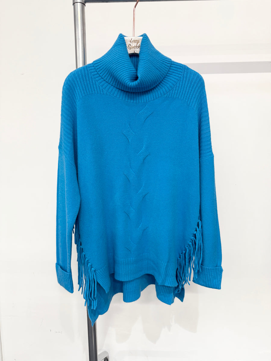 Soft Knit Jumper With Roll Neck,Rolled Sleeve Cuffs, Ribbed Shoulders, Cable Knit Design On Front And Side Tassels