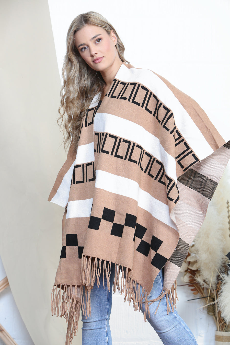 Pattered poncho with tassels