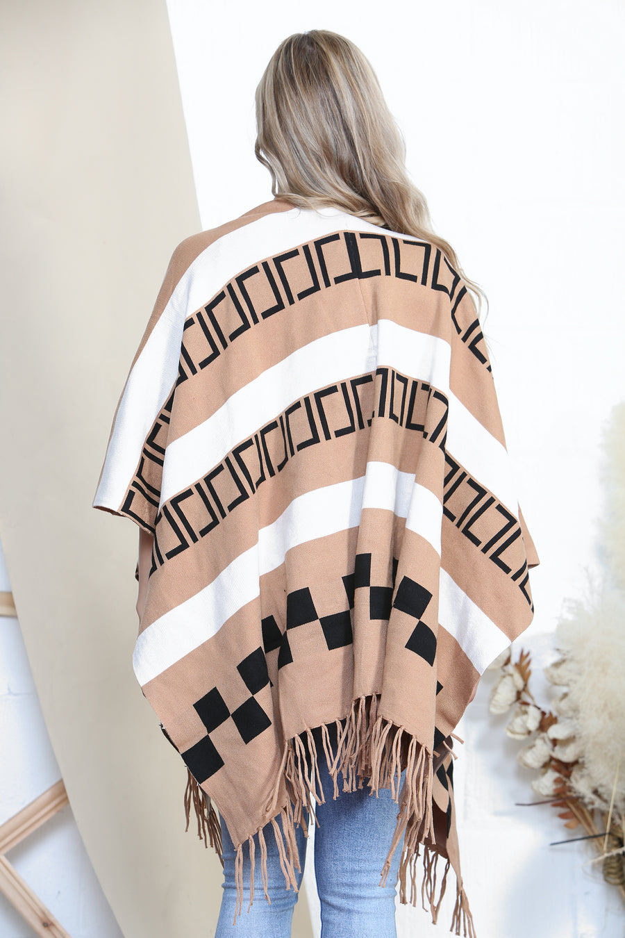 Pattered poncho with tassels