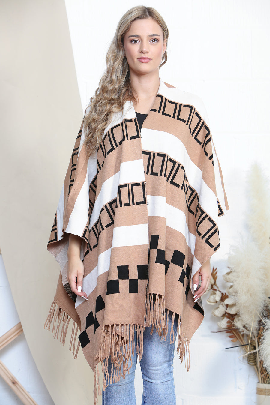 Pattered poncho with tassels